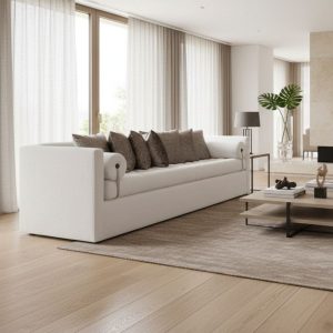 Canapé design contemporain crème et taupe en tissu bouclé, style minimaliste dans un salon lumineux